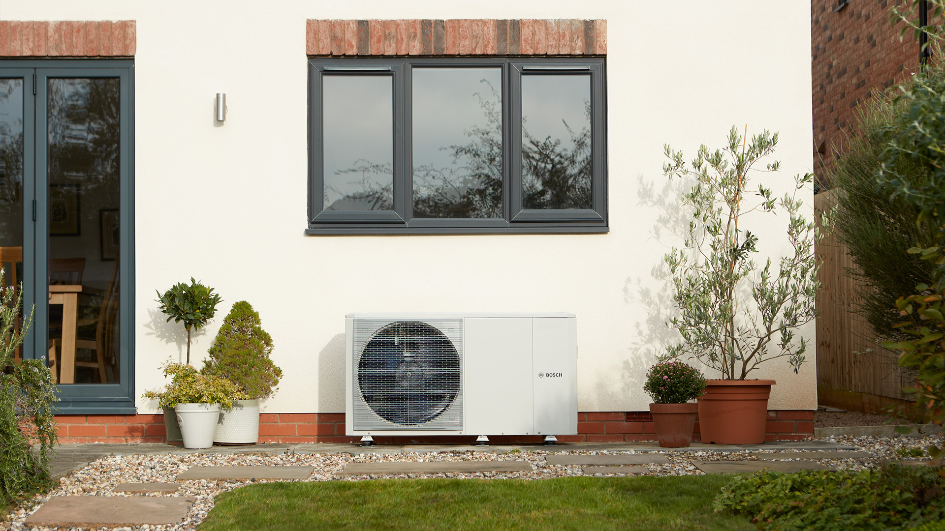 Bosch air source heat pump installed outside an older UK home